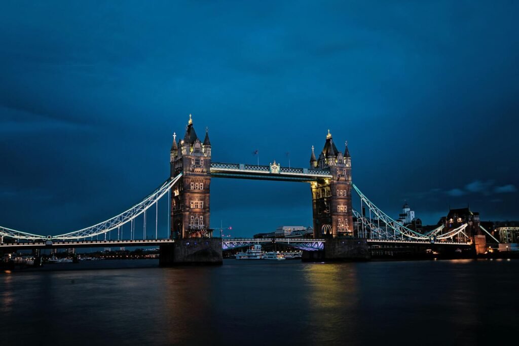 A stunning view of the illuminated Tower Bridge in London against a deep blue night sky.