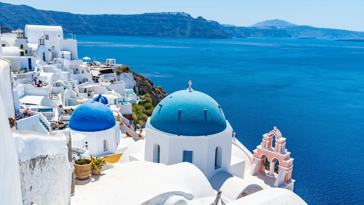 White,Buildings,And,Church,With,Santorini,Blue,Roof,And,View